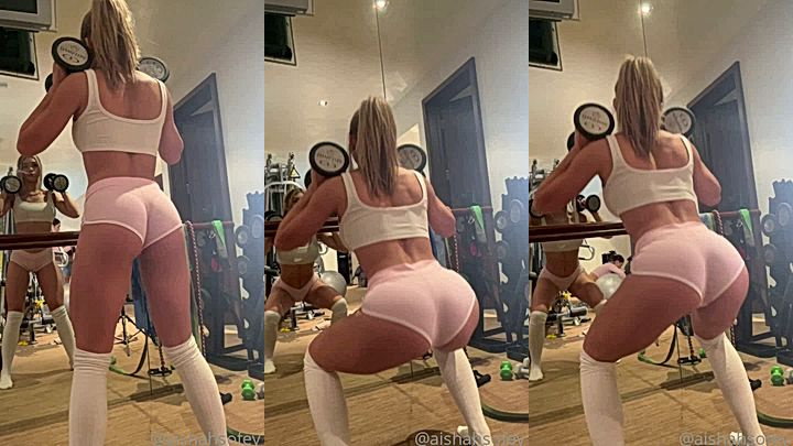 Aishah Sofey in a sexy lingerie squatting while carrying a dumbbell