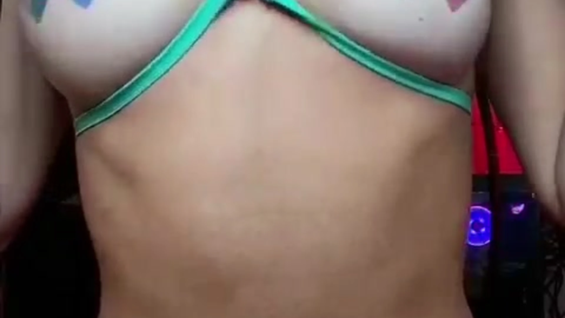 essaere pulling up her bra to show her tits with nipple cover on it