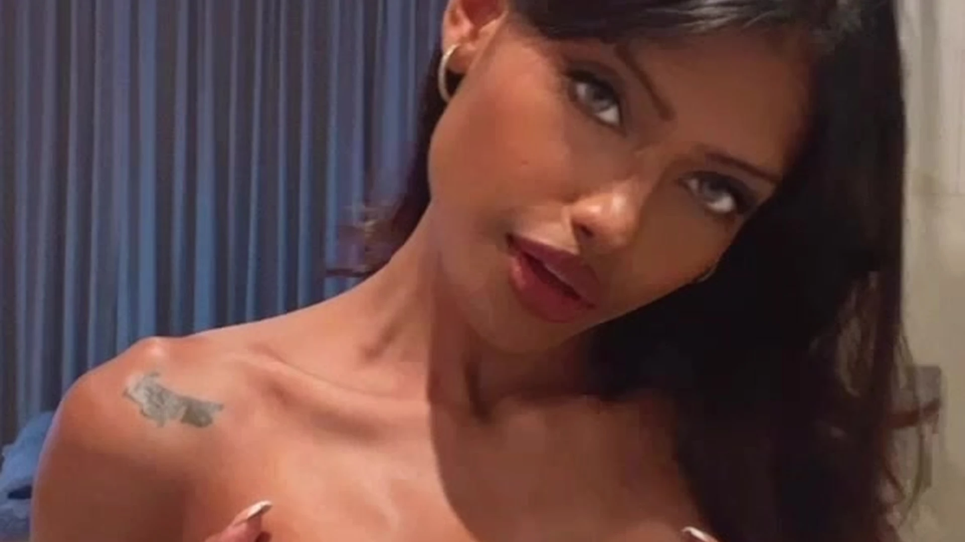 onlyfans Anna Celeste holding her small tits on camera
